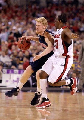 INDIANAPOLIS - MARCH 27:  Chase Budinger #34 of the Arizona Wildcats drives against Terrence Jennings #23 of the Louisville Cardinals  during the third round of the NCAA Division I Men's Basketball Tournament at the Lucas Oil Stadium on March 27, 2009 in 