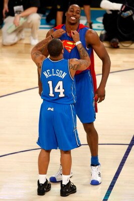 NEW ORLEANS - FEBRUARY 16:  Dwight Howard of the Orlando Magic gets help from teammate Jameer Nelson to put on a Superman costume for Howard's second dunk of the Sprite Slam Dunk Contest, part of 2008 NBA All-Star Weekend at the New Orleans Arena on Febru