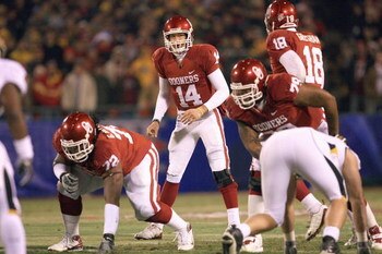 KANSAS CITY, MO - DECEMBER 06:  Quarterback Sam Bradford #14 of the Oklahoma Sooners calls the play at the line of scrimmage during the game against the Missouri Tigers on December 6, 2008 at Arrowhead Stadium in Kansas City, Missouri. (Photo by Jamie Squ