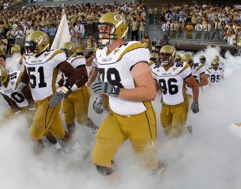 ATLANTA - AUGUST 28:  Members of the Georgia Tech Yellow Jackets, including linebacker Brad Jefferson #51, offensive lineman Clyde Yandell #78 and defensive lineman Logan Walls #96, run out of the tunnel before the game against the Jacksonville State Game