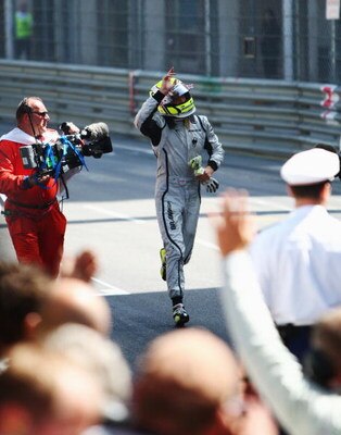 MONTE CARLO, MONACO - MAY 24:  Jenson Button of Great Britain and Brawn GP runs back to the podium after winning the Monaco Formula One Grand Prix at the Monte Carlo Circuit on May 24, 2009 in Monte Carlo, Monaco.  (Photo by Clive Mason/Getty Images)