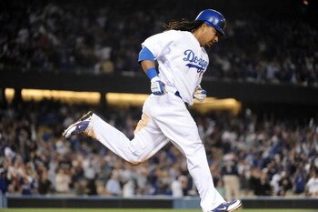 LOS ANGELES, CA - APRIL 30:  Manny Ramirez #99 of the Los Angeles Dodgers hits a homerun for a 4-3 lead against the San Diego Padres during the third inning at Dodger Stadium on April 30, 2009 in Los Angeles, California.  (Photo by Harry How/Getty Images)