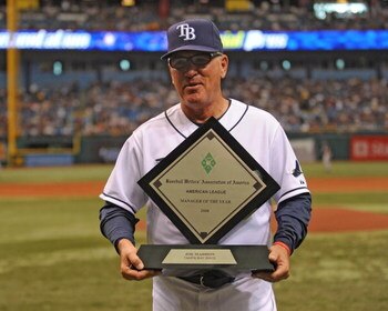 ST. PETERSBURG, FL - APRIL 19: Manager Joe Maddon #70 of the Tampa Bay Rays receives the American League coach of the year award before play against the Chicago White Sox April 19, 2009 at Tropicana Field in St. Petersburg, Florida.  (Photo by Al Messersc