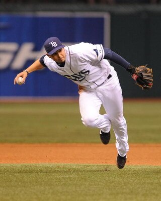 ST. PETERSBURG, FL - APRIL 30: Shortstop Jason Bartlett #8 of the Tampa Bay Rays fields a short infield ball that was the Boston Red Sox only hit April 30, 2009 at Tropicana Field in St. Petersburg, Florida.  (Photo by Al Messerschmidt/Getty Images)