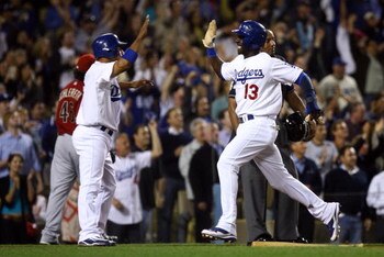 LOS ANGELES, CA - JUNE 02:  Rafael Furcal #15 and Orlando Hudson #13 of the Los Angeles Dodgers score on a double by James Loney in the eighth inning against the Arizona Diamondbacks at Dodger Stadium on June 2, 2009 in Los Angeles, California. The Dodger