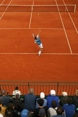 PARIS - JUNE 01:  Tim Henman of Great Britain serves as spectators look on against Dmitry Tursunov of Russia during day five of the French Open at Roland Garros on June 1, 2006 in Paris, France.  (Photo by Clive Brunskill/Getty Images)