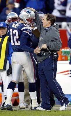 FOXBORO, MA - DECEMBER 27:  Head coach Bill Belichick congratulates quarterback Tom Brady #12 of the New England Patriots after he took Brady out of the game against the Buffalo Bills on December 27, 2003 at Gillette Stadium in Foxboro, Massachusetts. The