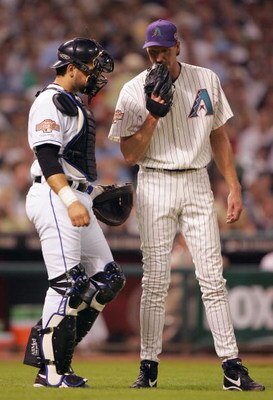 HOUSTON - JULY 13:  Mike Piazza (L) and Randy Johnson of the National Team talk near the mound during the third inning of the Major League Baseball 75th All-Star Game at Minute Maid Park on July 13, 2004 in Houston, Texas.  (Photo by Jed Jacobsohn/Getty I