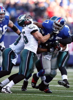EAST RUTHERFORD, NJ - JANUARY 11:  Brandon Jacobs #27 of the New York Giants runs against Stewart Bradley #55 of the Philadelphia Eagles during the NFC Divisional Playoff Game on January 11, 2009 at Giants Stadium in East Rutherford, New Jersey.  (Photo b