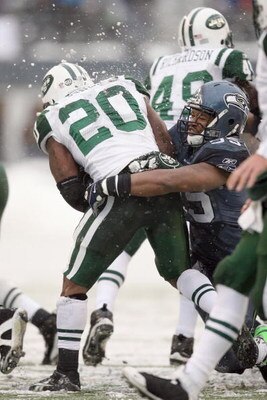 SEATTLE - DECEMBER 21:  Thomas Jones #20 of the New York Jets is tackled by Darryl Tapp #55 of the Seattle Seahawks on December 21, 2008 at Qwest Field in Seattle, Washington. The Seahawks defeated the Jets 13-3. (Photo by Otto Greule Jr/Getty Images)