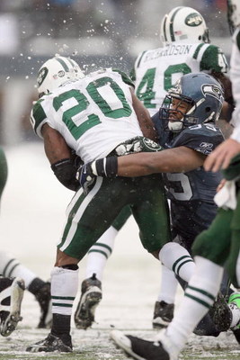 SEATTLE - DECEMBER 21:  Thomas Jones #20 of the New York Jets is tackled by Darryl Tapp #55 of the Seattle Seahawks on December 21, 2008 at Qwest Field in Seattle, Washington. The Seahawks defeated the Jets 13-3. (Photo by Otto Greule Jr/Getty Images)