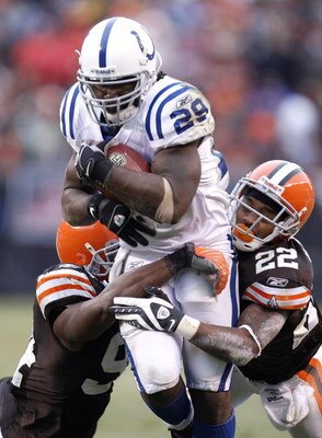 CLEVELAND - NOVEMBER 30:  Joseph Addai #29 of the Indianapolis Colts is tackled during a second quarter run by Brandon McDonald #22 and Leon Williams #94 of the Cleveland Browns on November 30, 2008 at Cleveland Browns Stadium in Cleveland, Ohio.  (Photo 