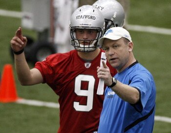 ALLEN PARK, MI - MAY 01:  Offensive coordinator Scott Linehan of the Detroit Lions talks with Matthew Stafford #9 during rookie orientation camp at the Detroit Lions Headquarters and Training Facility on May 1, 2009 in Allen Park, Michigan.  (Photo by Gre