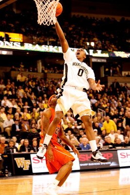 WINSTON-SALEM, NC - JANUARY 21:  Malcolm Delaney #23 of the Virginia Tech Hokies watches as Jeff Teague #0 of the Wake Forest Demon Deacons goes to the basket during their game at Lawrence Joel Coliseum on January 21, 2009 in Winston-Salem, North Carolina