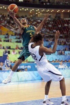 BEIJING - AUGUST 20:  Patrick Mills #5 of Australia drives to the basket over Chris Bosh #12 of the United States during the men's basketball quarterfinal game at the Olympic Basketball Gymnasium during Day 12 of the Beijing 2008 Olympic Games on August 2