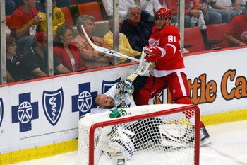 DETROIT - JUNE 06:  Goaltender Mathieu Garon #32 of the Pittsburgh Penguins gets knocked to the ice by Marian Hossa #81 of the Detroit Red Wings during Game Five of the 2009 NHL Stanley Cup Finals at Joe Louis Arena on June 6, 2009 in Detroit, Michigan.  