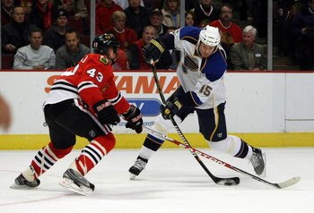 CHICAGO - JANUARY 21: Brad Winchester #15 of the St. Louis Blues fires a shot against James Wisniewski #43 of the Chicago Blackhawks on January 21, 2009 at the United Center in Chicago, Illinois. (Photo byJonathan Daniel/Getty Images)