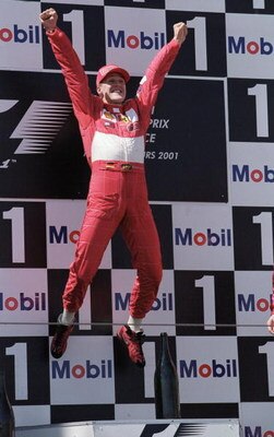 1 Jul 2001:  Michael Schumacher of Germany and Ferrari jumps for joy on the podium after winning the French Formula One Grand Prix at Magny Cours in France \ Mandatory Credit: Mark Thompson /Allsport