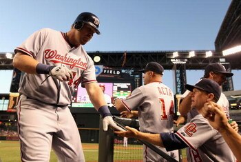 PHOENIX - MAY 08:  Adam Dunn #44 of the Washington Nationals is congratulated by coach Rick Eckstein after hitting a solo home run against the Arizona Diamondbacks during the third inning of the game at Chase Field on May 8, 2009 in Phoenix, Arizona.  (Ph