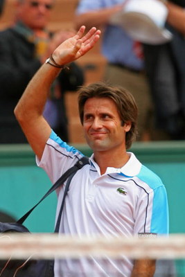 PARIS - MAY 27: Fabrice Santoro of France acknowledges the crowd following his Men's Singles First Round match against Christophe Rochus of Belgium on day four of the French Open at Roland Garros on May 27, 2009 in Paris, France. (Photo by Matthew Stockma