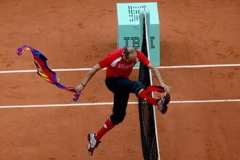 PARIS - JUNE 07:  An intruder jumps the net after interfering with Roger Federer of Switzerland during the Men's Singles Final match between Robin Soderling of Sweden and Roger Federer of Switzerland on day fifteen of the French Open at Roland Garros on J