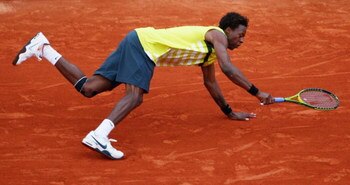 PARIS - JUNE 01:  Gael Monfils of France falls whilst trying to reach the ball during the Men's Fourth Round match against Andy Roddick of USA on day nine of the French Open at Roland Garros on June 1, 2009 in Paris, France.  (Photo by Clive Brunskill/Get