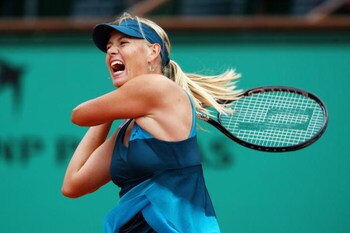 PARIS - MAY 31:  Maria Sharapova of Russia hits a forehand during the Women's Singles Fourth Round match against Na Li of China on day eight of the French Open at Roland Garros on May 31, 2009 in Paris, France.  (Photo by Clive Brunskill/Getty Images)