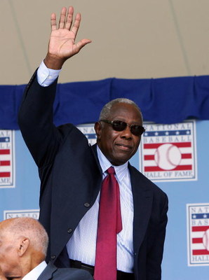 COOPERSTOWN, NY - JULY 27:  Baseball legend and Hall of Famer Hank Aaron waves to the crowd at Clark Sports Center as he is introduced prior to the Baseball Hall of Fame induction ceremony on July 27, 2008 in Cooperstown, New York.  (Photo by Jim McIsaac/
