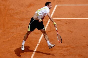PARIS - JUNE 07:  Robin Soderling of Sweden servesduring the Men's Singles Final match against Roger Federer of Switzerland on day fifteen of the French Open at Roland Garros on June 7, 2009 in Paris, France.  (Photo by Matthew Stockman/Getty Images)