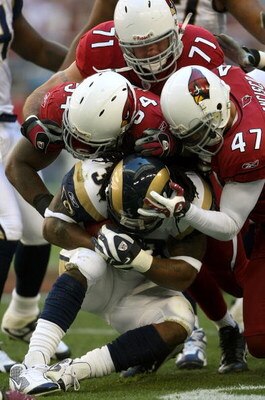 GLENDALE, AZ - DECEMBER 30:  Running back Steven Jackson #39 of the St. Louis Rams is stopped by defenders Gerald Hayes #54, Joe Tafoya #71, and Aaron Francisco #47 of the Arizona Cardinals at University of Phoenix Stadium December 30, 2007 in Glendale, A