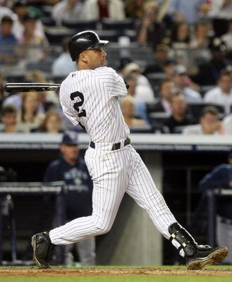 NEW YORK - JUNE 08:  Derek Jeter #2 of the New York Yankees hits a solo home run in the eighth inning against the Tampa Bay Rays on June 8, 2009 at Yankee Stadium in the Bronx borough of New York City.  (Photo by Nick Laham/Getty Images)
