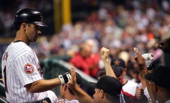 HOUSTON - APRIL 19:  Brad Ausmus #11 of the Houston Astros celebrates with teammates in the dugout after scoring a run in the fifth inning against the Milwaukee Brewers on April 19, 2006 at Minute Maid Park in Houston, Texas.  (Photo by Ronald Martinez/Ge