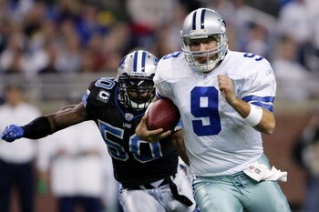 DETROIT - DECEMBER 09:  Quarterback Tony Romo #9 of the Dallas Cowboys makes a break chased by Ernie Sims #50 of the Detroit Lions on December 9, 2007 at Ford Field in Detroit, Michigan. The Cowboys won the match 28-27.  (Photo by Chris McGrath/Getty Imag