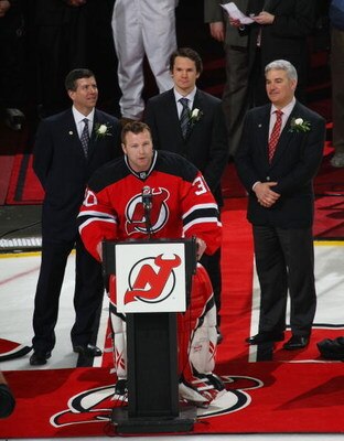 NEWARK, NJ - APRIL 03: Martin Brodeur #30 of the New Jersey Devils is honored for his NHL record breaking 552nd win by Chairman and Managing Partner of the Devils Jeff Vanderbeek (R), Co-Owner Mike Gilfillan (R), and Patrik Elias (C)  prior to the Devils 
