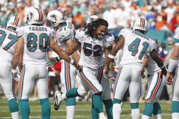 MIAMI - JANUARY 4:  Channing Crowder #52 of the Miami Dolphins runs onto the field before an AFC Wild Card playoff game against the Baltimore Ravens on January 4, 2009 at Dolphin Stadium in Miami, Florida. (Photo by Gregory Shamus/Getty Images)