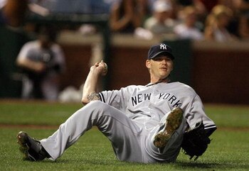 ARLINGTON, TX - MAY 27:  Pitcher A.J. Burnett #34 of the New York Yankees falls while trying to make the throw on a bunt single by Elvis Andrus #1 of the Texas Rangers on May 27, 2009 at Rangers Ballpark in Arlington, Texas.  (Photo by Ronald Martinez/Get