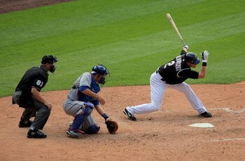 DENVER - MAY 27:  Troy Tulowitzki #2 of the Colorado Rockies strikes out swinging, representing the winning run at the plate as catcher Russell Martin #55 of the Los Angeles Dodgers and home plate umpire Scott Barry look on at Coors Field on May 27, 2009 
