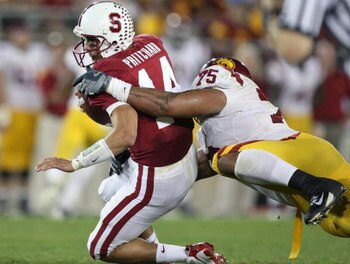STANFORD, CA - NOVEMBER 15:  Tavita Pritchard #14 of the Stanford Cardinals is sacked by Fili Moala #75 of the USC Trojans at Stanford Stadium on November 15, 2008 in Stanford, California.  (Photo by Jed Jacobsohn/Getty Images)