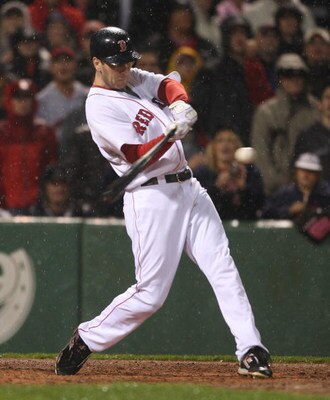 BOSTON - JUNE 11: Jason Bay #44 of the Boston Red Sox hits a single to knock in a run to tie the New York Yankees at Fenway Park on June 11, 2009 in Boston, Massachusetts.  (Photo by Jim Rogash/Getty Images)