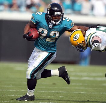 JACKSONVILLE, FL - DECEMBER 14:  A. J. Hawk #50 of the Green Bay Packers attempts to tackle Maurice Jones-Drew #32 of the Jacksonville Jaguars during the game at Jacksonville Municipal stadium on December 14, 2008 in Jacksonville, Florida.  (Photo by Sam 