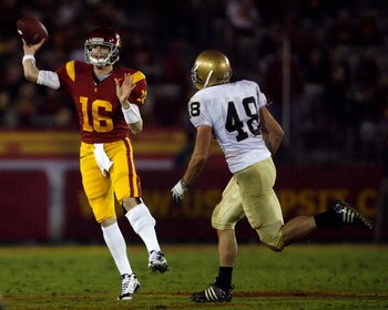 LOS ANGELES, CA - NOVEMBER 29:  Mitch Mustain #16 of the USC Trojans passes in front of Steve Quinn #48 of the Notre Dame Fighting Irsh during the fourth quarter at the Coliseum on November 29, 2008 in Los Angeles, California.  (Photo by Harry How/Getty I