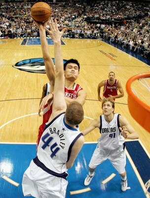 DALLAS - JANUARY 12:  Center Yao Ming #11 of the Houston Rockets takes a shot against Shawn Bradley #44 of the Dallas Mavericks at the American Airlines Center on January 12, 2005  in Dallas, Texas.   (Photo by Ronald Martinez/Getty Images) 