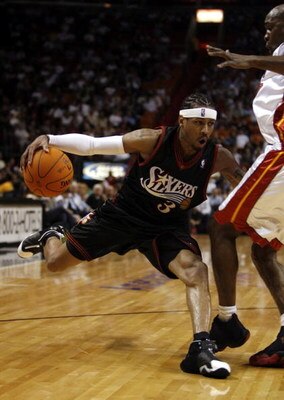MIAMI - NOVEMBER 27:  Antoine Walker #8 of the Miami Heat tangles with Allen Iverson #3 of the Philadelphia 76ers in the first period November 27, 2006 at the American Airlines Arena in Miami  Florida. NOTE TO USER: User expressly acknowledges and agrees 