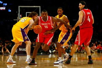 LOS ANGELES, CA - MAY 04:  Ron Artest #96 of the Houston Rockets drives through Pau Gasol #16 and Trevor Ariza #3 of the Los Angeles Lakers in the third quarter in Game One of the Western Conference Semifinals during the 2009 NBA Playoffs at Staples Cente