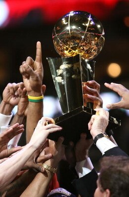 DALLAS - JUNE 20:  The Miami Heat hold up the Larry O'Brien trophy after they defeated the Dallas Mavericks in game six of the 2006 NBA Finals on June 20, 2006 at American Airlines Center in Dallas, Texas.  The Heat won 95-92 and win the series 4-2.  NOTE