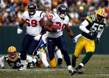 GREEN BAY, WI - DECEMBER 07:  Running back Steve Slaton #20 of the Houston Texans carries the ball while being pursued by Desmond Bishop #55 of the Green Bay Packers during the first half at Lambeau Field on December 7, 2008 in Green Bay, Wisconsin. The T