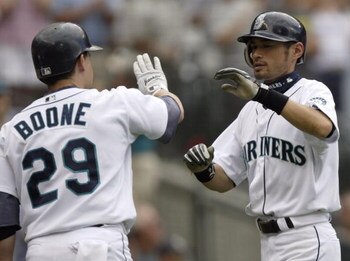 SEATTLE - JULY 18:  Ichiro Suzuki #51 of the Seattle Mariners is congratulated by Bret Boone #29 after scoring in the 8th inning against the Cleveland Indians on July 18, 2004 at Safeco Field in Seattle, Washington. (Photo by Otto Greule Jr/Getty Images)
