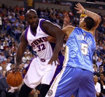 INDIAN WELLS, CA - OCTOBER 11:  Shaquille O'Neal #32 of the Phoenix Suns is defended by Juwan Howard #5 of the Denver Nuggets during the second quarter of a preseason game at the Indian Wells Tennis Garden on October 11, 2008 in Indian Wells, California. 