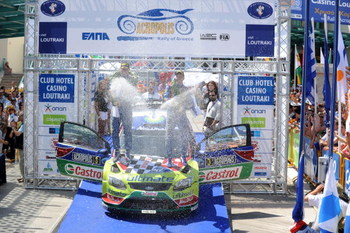 LOUTRAKI, GREECE - JUNE 14: Mikko Hirvonen of Finland and Jarmo Lehtinen of Finland celebrate victory on the podium after winning the WRC Acropolis Rally of Greece on June 14, 2009 in Loutraki, Greece (Photo by Massimo Bettiol/Getty Images)