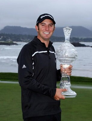 PEBBLE BEACH, CA - FEBRUARY 16:  Dustin Johnson poses with the trophy on th e18th green at Pebble Beach Golf Links after cancellation of the final round of the the AT&T Pebble Beach National Pro-Am on February 16, 2009 in Pebble Beach, California.  (Photo